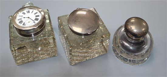 An Edwardian silver mounted cut glass inkwell, with inset pocket watch cover, John Grinsell & Sons, London, 1906 & 2 other inkwells.